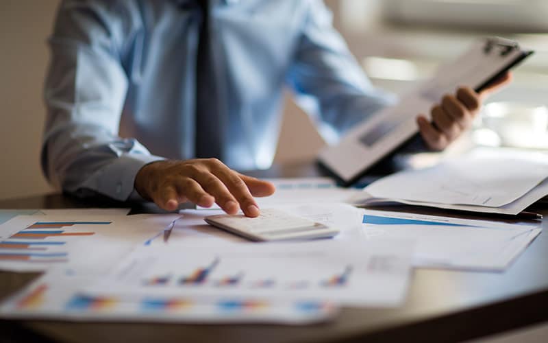 Calculations image Employee completing calculations to reduce cost image
